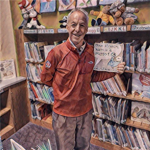 Mr. Clark holding a book in front of a bookshelf